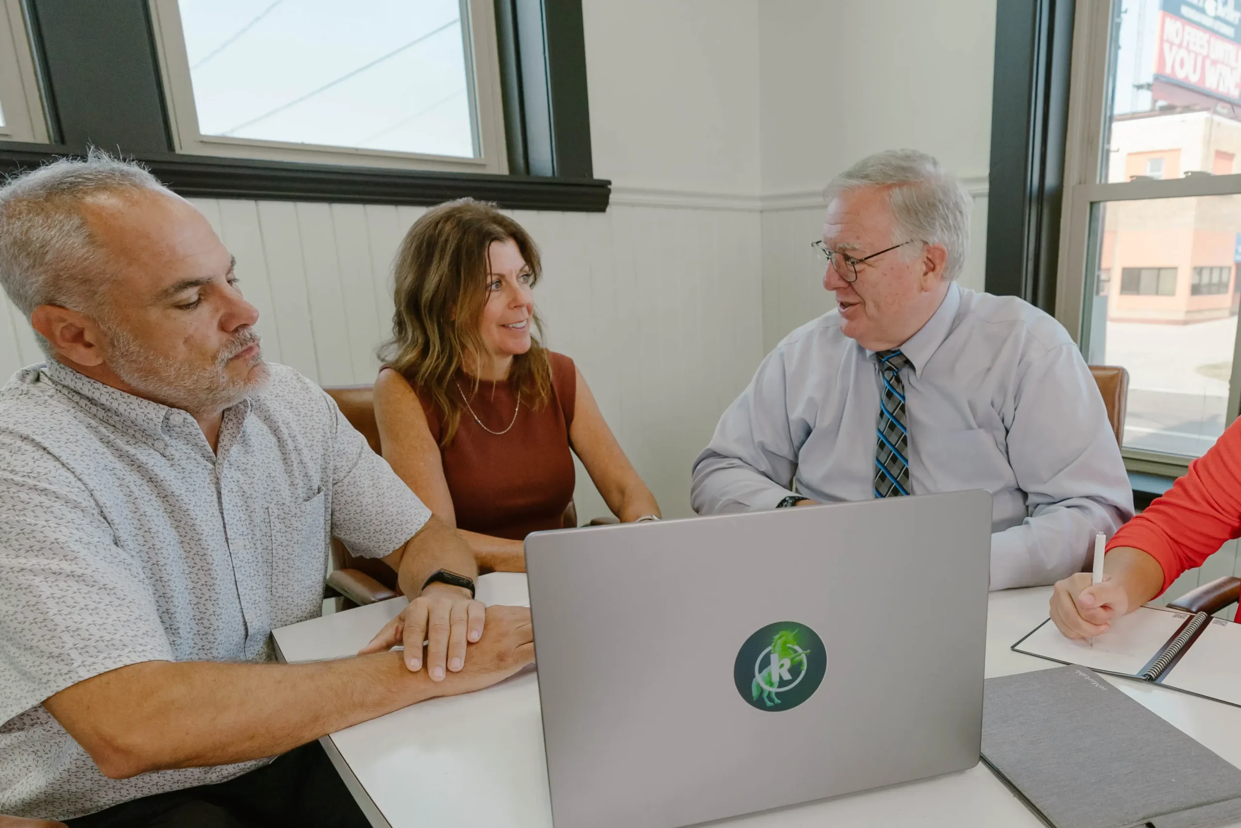 A group of people talking to a broker about buying a business in Michigan.