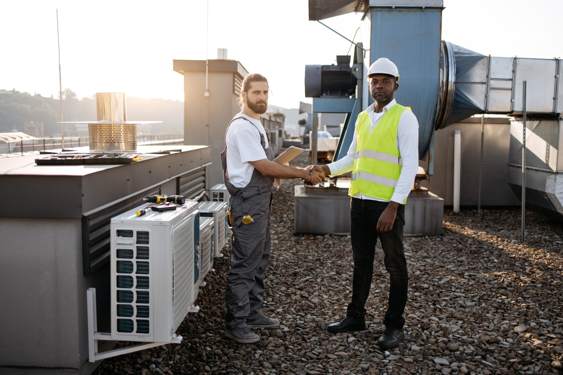 An HVAC business broker meets with a business owner in the field.